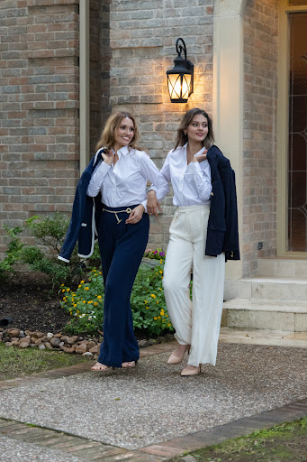 Lifestyle example photo with two women standing by a brick wall